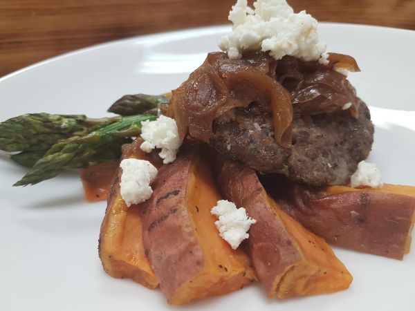 Burger topped with Goat Cheese and Sweet Potato Wedges and Grilled Asparagus