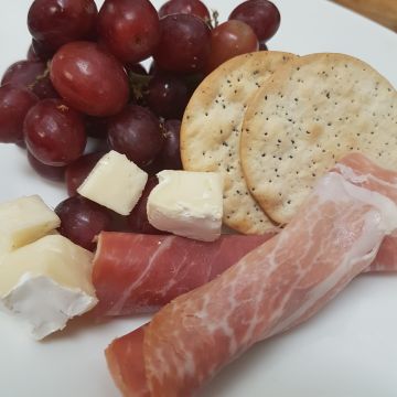 Chef's Charcuterie Board served with Brie Cheese, Prosciutto, Grapes and Crackers