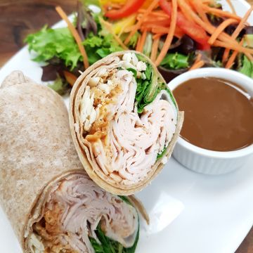 Chipotle Turkey Wrap with roasted Turkey, Havarti Cheese, Arugula, Sundried Tomatoes and Chipotle Aioli, served with Mixed Green Salad with Balsamic Vinaigrette