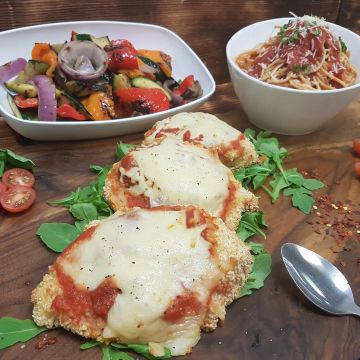 Chicken Parmigiana served with Pasta and Grilled Vegetables.